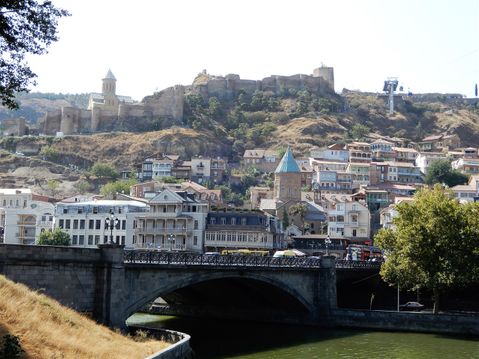 Metekhi Bridge and Narikala Citadel in the background.