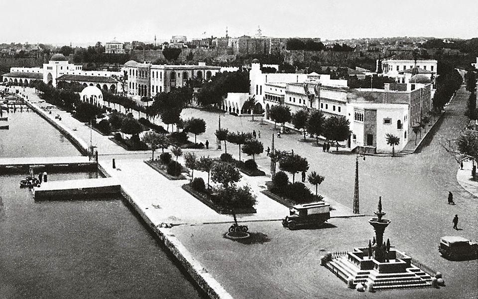 A 20's picture taken from the bell tower of San Giovanni showing the promenade in front of of Mandraki port, where today moor the yachts.   At the end of the promenade you can see the New Market and in the background the Palace inside the Medieval Town walls.