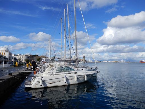 Yachts moored outside New market at Mandraki port.