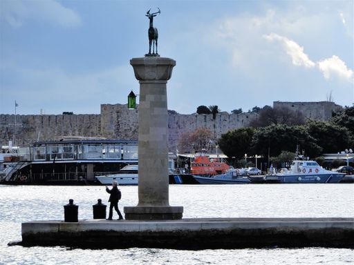 One of the two deer standing at the endrance of Mandraki Port.