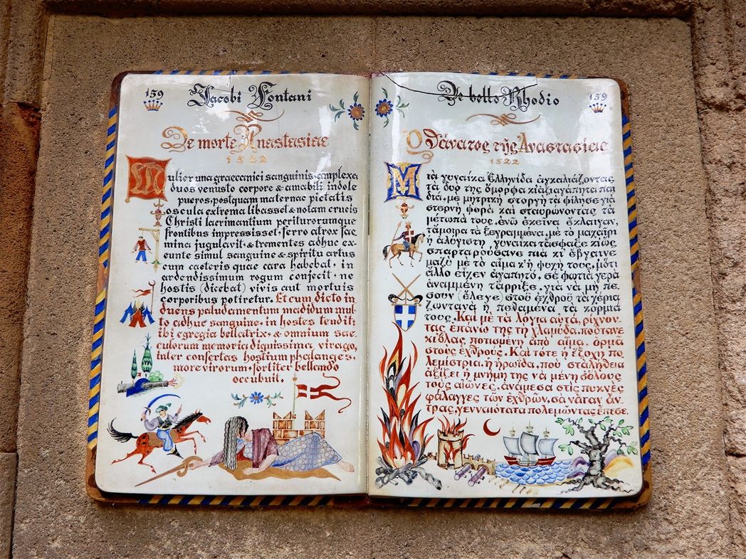 When Rhodos was beleaguered and kneed because of the Ottoman enemies (during the 1522 siege), Anastassia proved to be an example of great heroism. She was a beautiful Greek woman, whose husband was an English Knight who killed in the first line.  When she saw her husband’s death, run to the house kissed and hugged her two children and then killed them and threw them in the fire so the Turks would not find them.  With courage she put on the bloody armor of her husband and fought the enemy. She killed a lot of Turks when she came to the first line of the glory battle until she was killed. When Rhodos was freed, she was awarded remembrance with a panel on the wall of the external entrance of Castello. Anastassia is an example of imitation and heroism and a street is named after her.