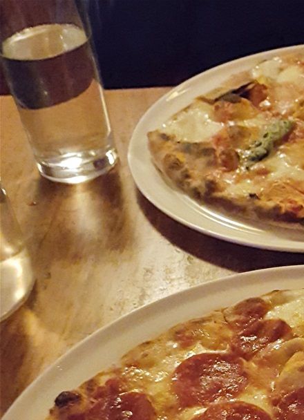 A yummy afumicatta (smoked Mozzarella, cherry tomatoes, hot sausage) and the humble Margherita in the background.
