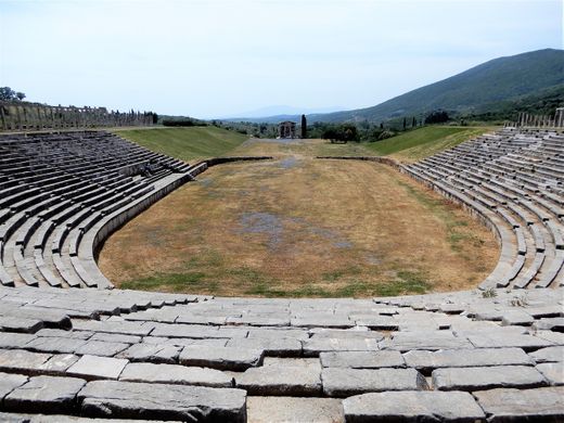 The Stadium is a prestigious building complex. It has a horseshoe shape, with ramps and stairwells, seats for the prominent citizens.  At the bottom there is a Roman addition of protective walls as in those years it was turned into an arena. The northern horseshoe section of the Stadium includes 18 stands with 18 rows of seats, separated by staircases.  It is surrounded by Doric arcades, whose columns are mostly in place. The northern arcade is double, the eastern and the western are simple.