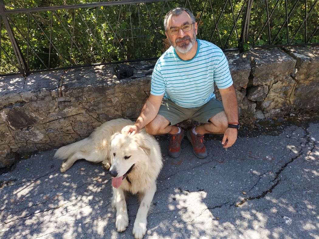With a stray dog outside the gate of Aimialon Monastery.
