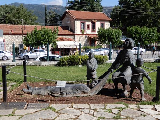 Τhis moving sculpture is located in the courtyard of the Μuseum of the Kalavryta Holocaust.  The building at the background is the town Railway Station.