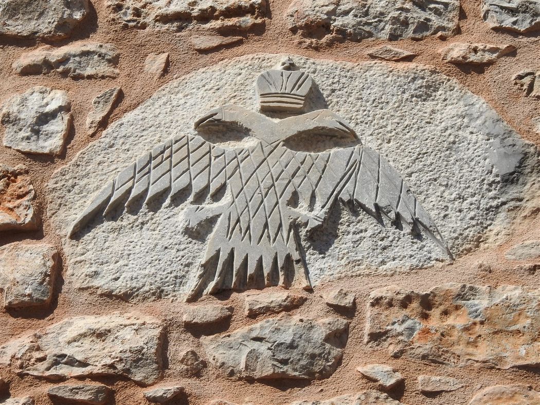 The Byzantine two-headed eagle carved at the facade of a house in Areopoli.