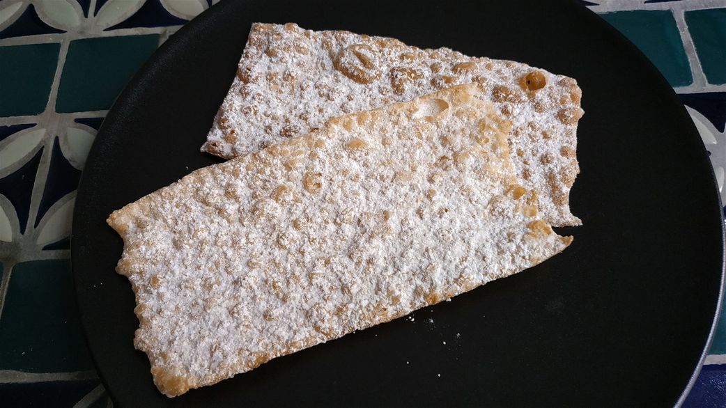 “Bugnes” are fried pasties that come mainly in two varieties: crunchy bugnes and soft bugnes. The crunchy variety, known as “bugnes lyonnaises” (the ones in the picture), are cooked in very hot oil with the dough spread out thinly and knotted once or twice. The soft variety, known as 