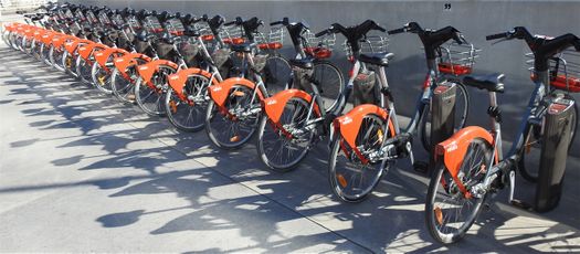 The characteristick red Vélo'v bicycles at a parking station outside the Musée des Confluences.