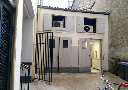 The little courtyard of my building in Lyon. They grey doors lead to the bakery ovens.
