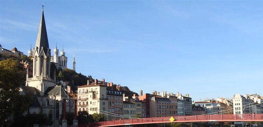 The red Passerelle St Georges and the Église Saint Georges in Vieux Lyon.