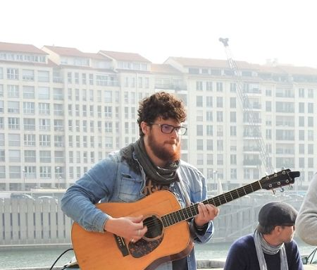 A group of musicians at the right bank of Saone River, in front of the Palais de Bondy.