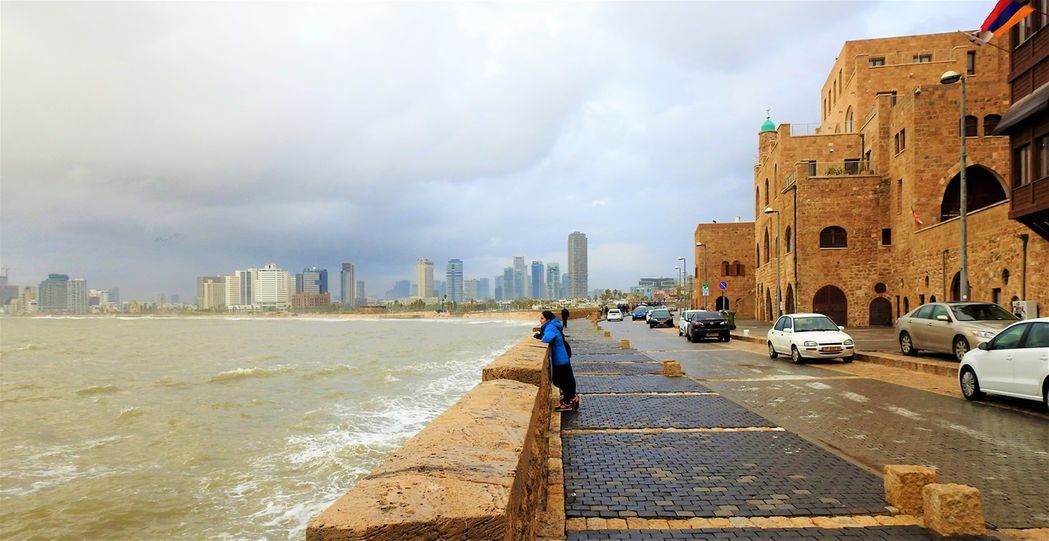 Retzif HaAliya HaShniya street in front of old Jaffa Harbor.  Tel Aviv's skyline is in the background.