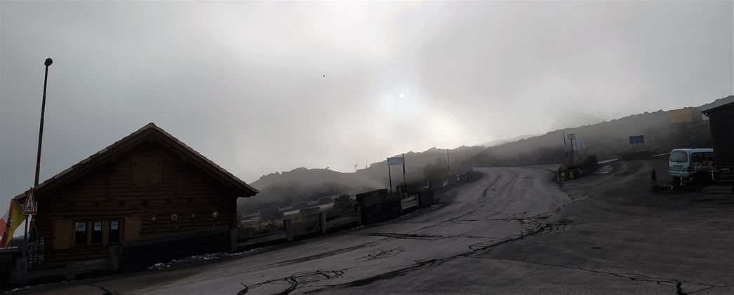The smoke coming out from Etna covers the summer sun.