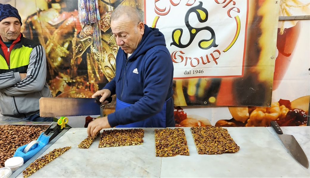 Street vendor selling torrone (candied pistachio).