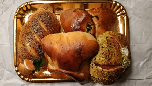 A variety of sicilian staffed/covered sicilian pizza rolls (Pezzi Di Rosticceria). 