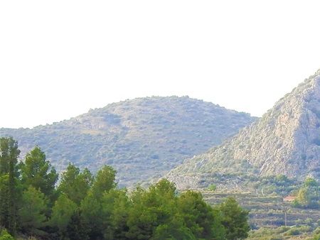 Looking towards the countryside from atope the Asini acropolis.  The conical rock is the hill of the prophet Elias on top of which stands the little chapel.