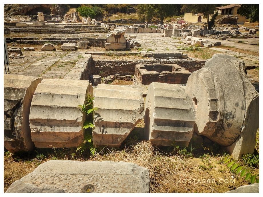 A fallen pillar (part of the northwest stoa) and behind it the Eschára where the sacrifices were made.