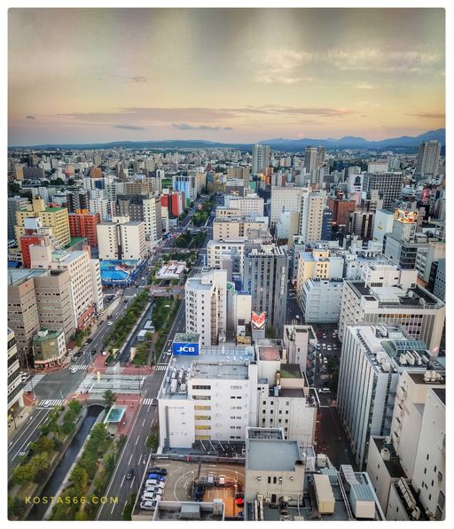 Sosei River and Nijo Market (the building on the left bank with the blue roof) seen from the observation deck of Sapporo TV Tower.