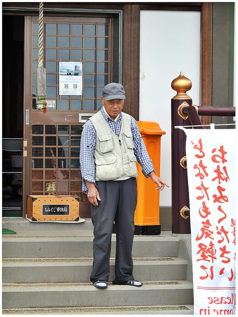 The monk of the small Buddhist Temple next to the summit observation deck of Mount Moiwa.