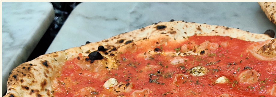 'L' Antica Pizzeria da Michele' serves only two kinds of pizza: marinara (left) and margherita (right).