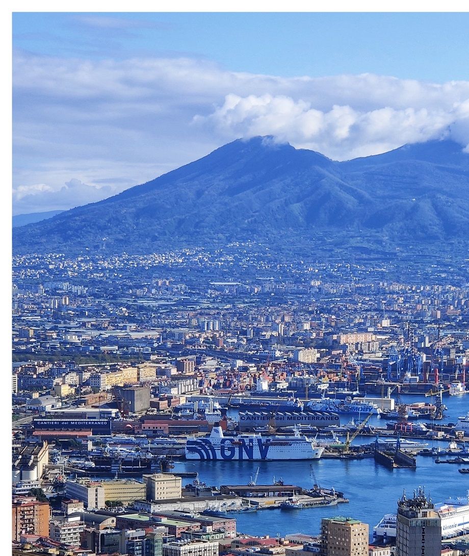 The harbor of Napoli and cloud-covered Mount Vesuvius in the background.