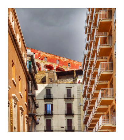 The red building seen on the top of the hill is Caserma Nino Bixio. The rest of the buildings are apartment blocks build at the foothills.