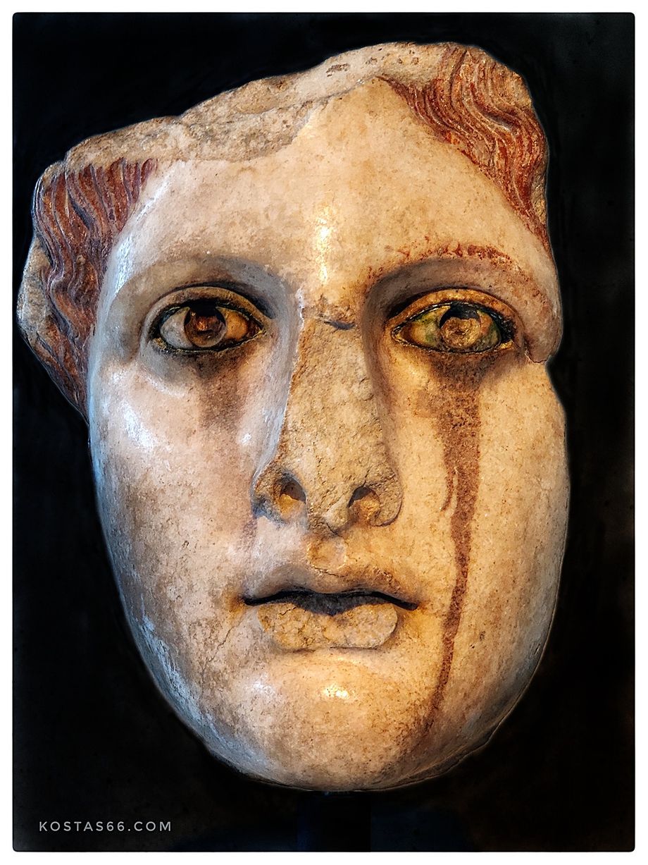 Head of female statue.  A marble copy of a gold-and ivory statue of the classical period (5th-4th cent BC). It represents a goddess, perhaps Aphrodite. The color that has leaked below her eyes is a product of the oxidation of the statue's bronze eyelashes.