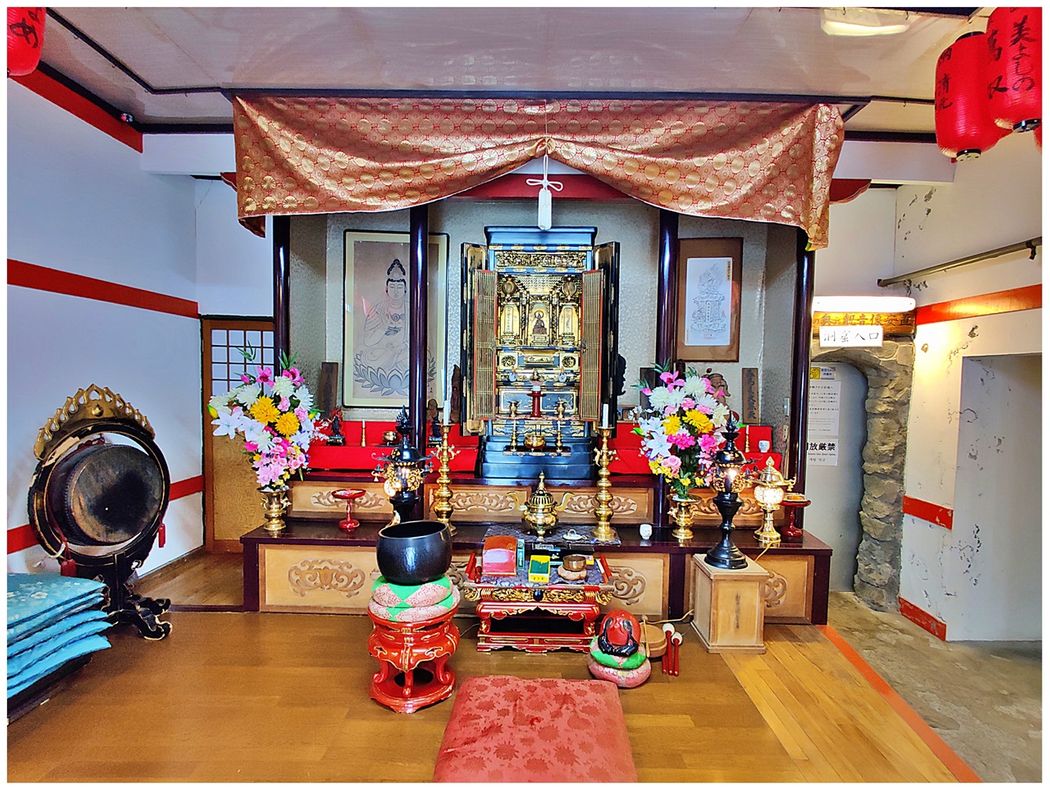 Inside Iwato Kannon-do Temple.  The little grey door on the right is the entrance to the cave with the statues of Kannon.
