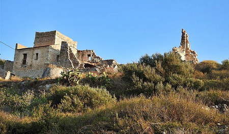 The ruins of pirate’s Nikolos Sassaris tower-house seen from the small pebbly Kato Mezapos beach.