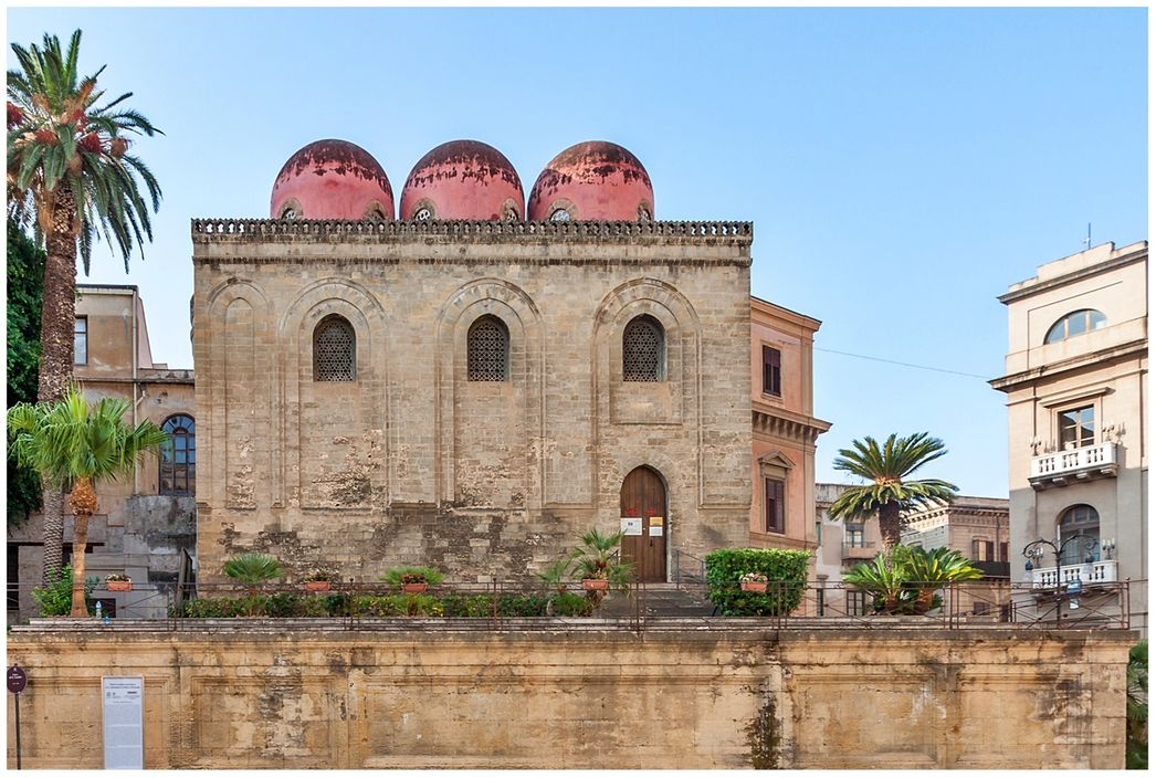 The north facade of Chiesa San Cataldo on Piazza Bellini. The ceiling has three characteristics red, bulge domes (cubole).