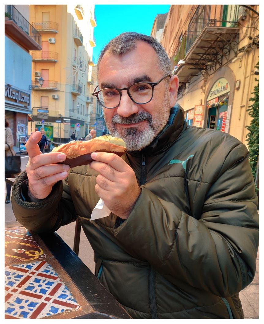 Enjoying a pistachio cannolo at 'Cannoli & Co' in Via Maqueda.