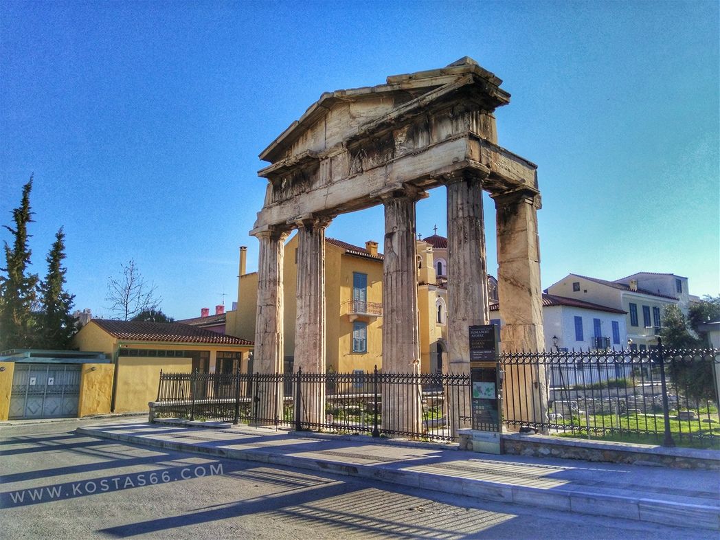 The entrance to the archaelogical site of Athens Ancient Agora. Gate of Athena Archegetis. The inscription is hard to make out on the photo but it is there on the plain row of blocks above the top of the columns.