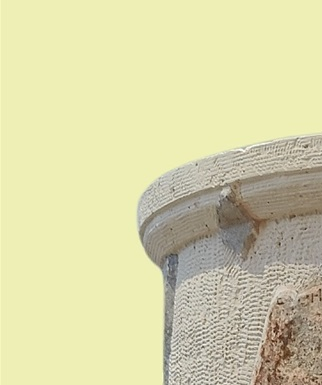 The big cylindrical altar that was found at the Brauron sanctuary was restored in 1967 from 28 pieces that were retrieved from different parts of the archaeological site. The fragmentary scene on the altar consisted of 15 relief figures that were arranged in order while above the head of each figure there was an inscription with its name. According to an interpretive approach, the scene's theme is the welcoming reception of Dionysus as a guest deity to the sanctuary of Artemis Brauronia. The procession was led by Hermes and the figures that followed are identified with Dionysus, the three Horae with Eirene first in order, the three Graces, a Silenus figure,  the three Nymphs - the last of which is depicted seated - Apollo, Leto and Artemis.  The altar is dated around 400 B.C., which is the period right after the end of the Peloponnesian War, when peace was re-established in Attica. This fact may have been the reason for the artist to place Eirene right after Dionysus who was leading along with Hermes the procession towards the temple of Artemis.  A different approach identifies at the first part of the scene, which took place at the sanctuary of Delphi, Leto, Artemis, Apollo and Pythia, seated next to him on the Omphalos. At the next scene a procession begins with Hermes and Dionysus in charge, followed by the goddess Eirene and more groups of secondary female deities that participate in the procession. A male deity is discerned among them and could be interpreted as 